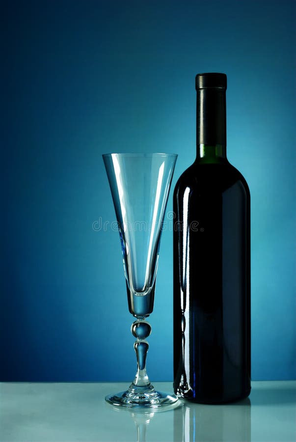 Wine bottle and glass on a blue background