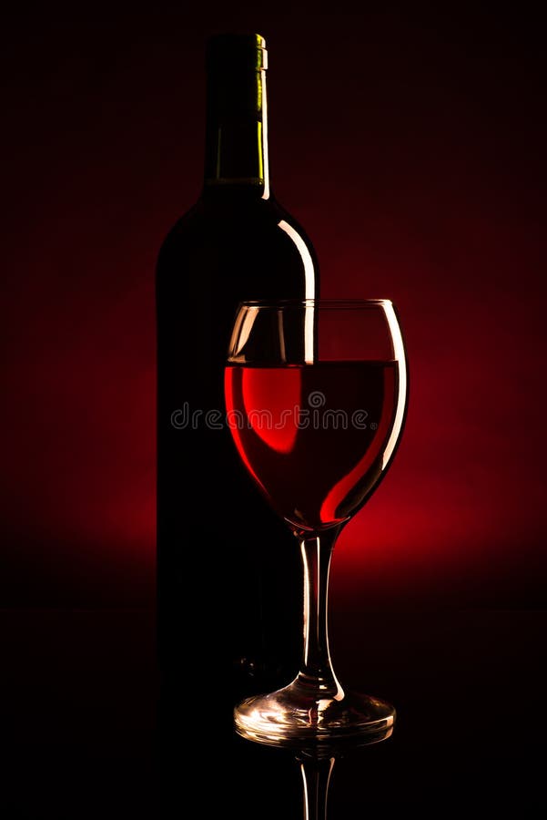 Wine bottle and glass silhouette over dark red