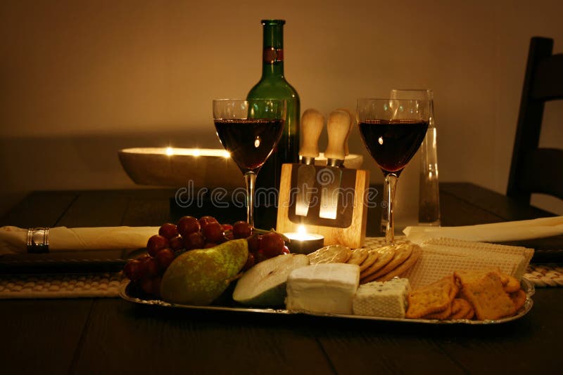 Vino, vari tipi di formaggio, cracker e frutta.