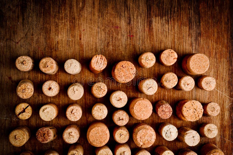 Wine Corks of Different Sizes, Standing Upright on an Old Wooden Surface. Background for Liquor