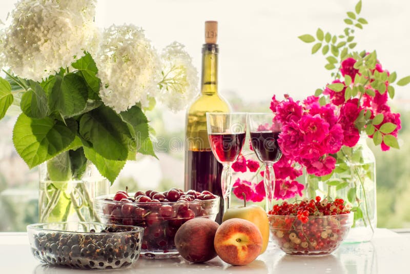 Wine, fruit, berries and flowers.