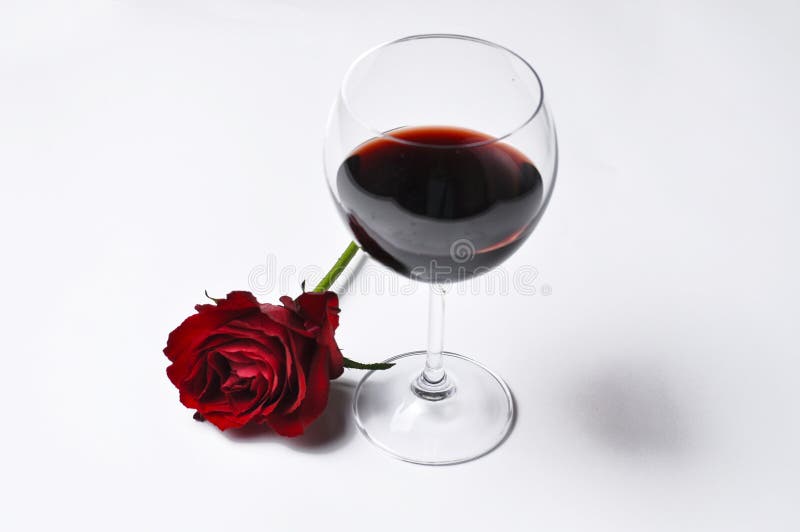 Wine glass and beautiful red rose isolated on white background.Copy space