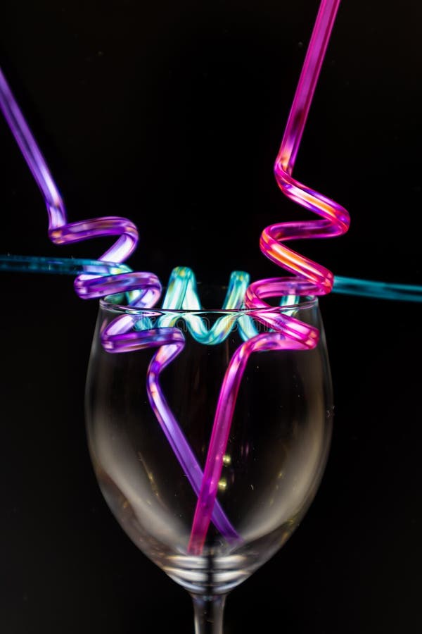 Wine Glass and Colourful Straws. Stock Image - Image of creative