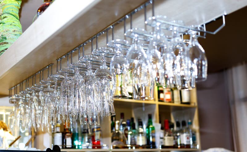 Wine glass hanging oh shelf in pub & restaurant stock photo Wine glass hanging oh shelf in pub & restaurant stock photo