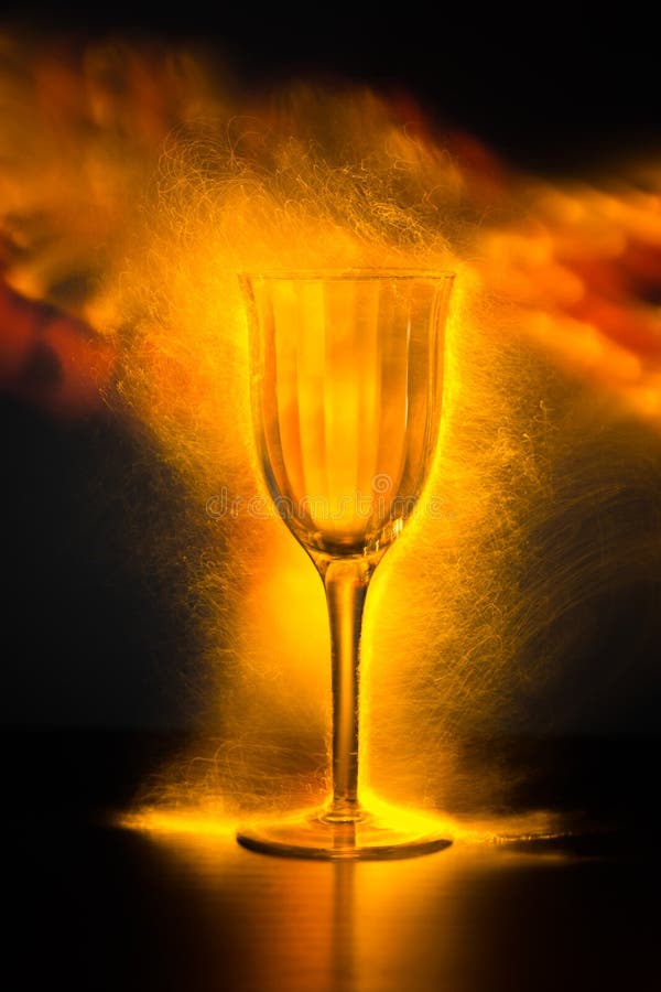 Wine Glass with Sparks and Misty Fire Light