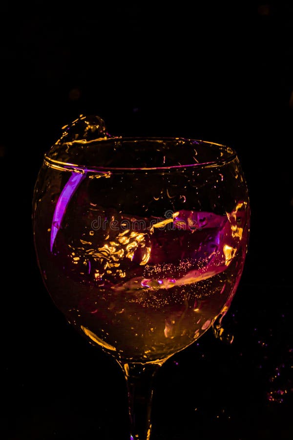 Wine Glass with Splashing on Black Background. Celebration Concept