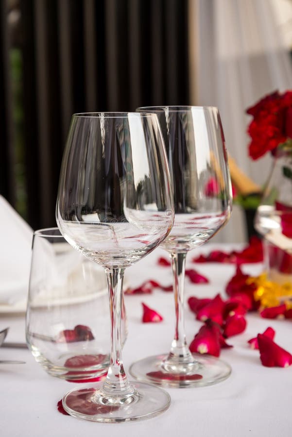 Wine glass table set with rose petals decorations