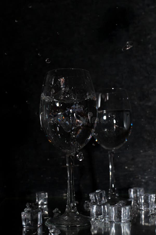 https://thumbs.dreamstime.com/b/wine-glasses-black-background-pieces-ice-liquid-spills-out-glasses-wine-glasses-black-background-214282043.jpg