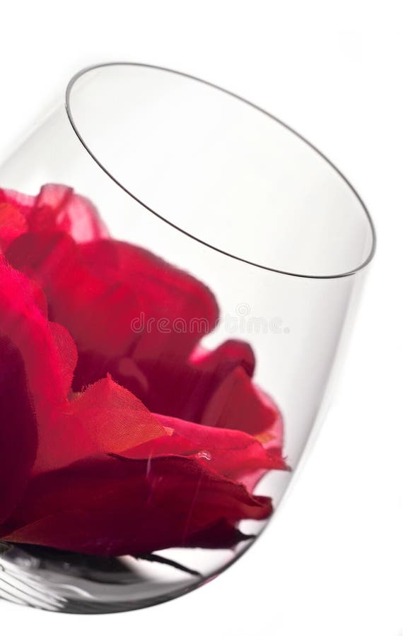 Wine glass in backlight with red flower. Wine glass in backlight with red flower