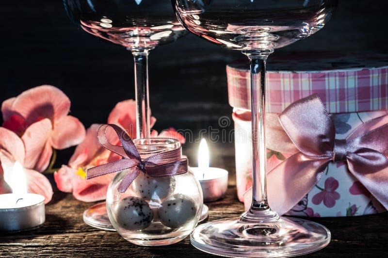 Wine Glasses Orchids and Candles for a Romantic Evening Stock Photo