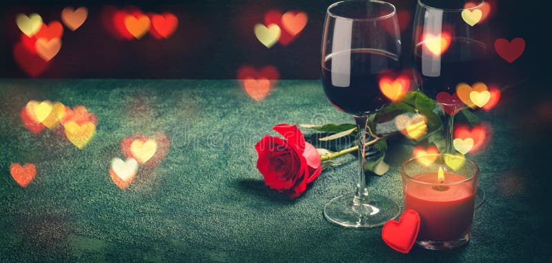 Wine glasses, rose and hearts bokeh lights. Valentines day concept. Banner format