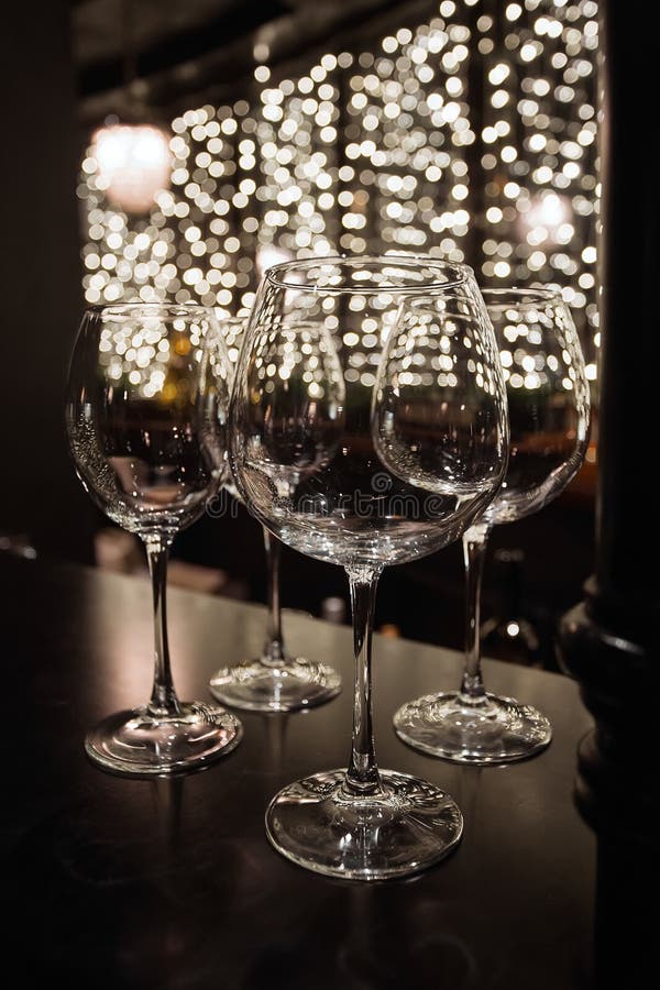 Wine Glasses in Shelf Above a Bar Rack in Restaurant Stock Photo