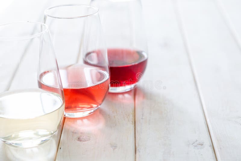 WIne tasting concept - red, rose and white wine in glasses stock photography WIne tasting concept - red, rose and white wine in glasses stock photography