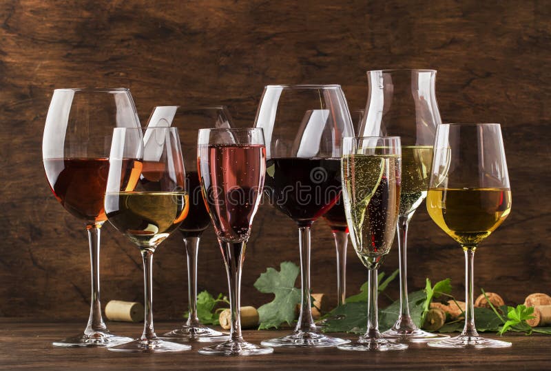 Wine tasting, still and sparkling wines. Red, white wine, rose and champagne шт assortment in wine glasses on vintage wooden table  background. Wine tasting, still and sparkling wines. Red, white wine, rose and champagne шт assortment in wine glasses on vintage wooden table  background