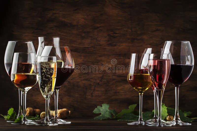 Wine tasting, still and sparkling wines. Red, white wine, rose and champagne шт assortment in wine glasses on vintage wooden table background. Wine tasting, still and sparkling wines. Red, white wine, rose and champagne шт assortment in wine glasses on vintage wooden table background