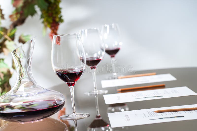 Wine tasting table set with decanter and glasses.