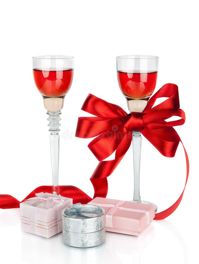 Wine in two wineglasses with red satin bow and gift box isolat