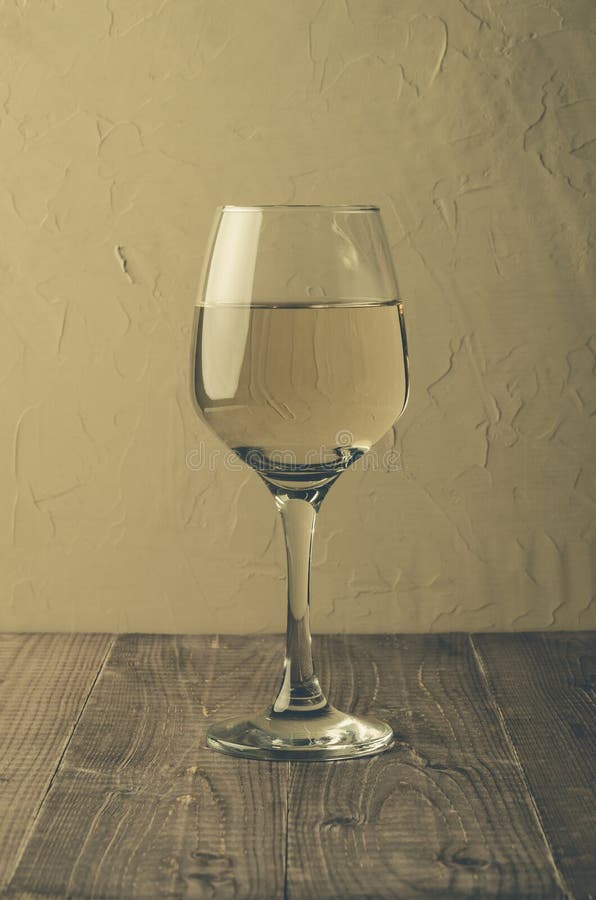 Wine on wooden table/glass of white wine on a wooden table, selective focus royalty free stock image Wine on wooden table/glass of white wine on a wooden table, selective focus royalty free stock image