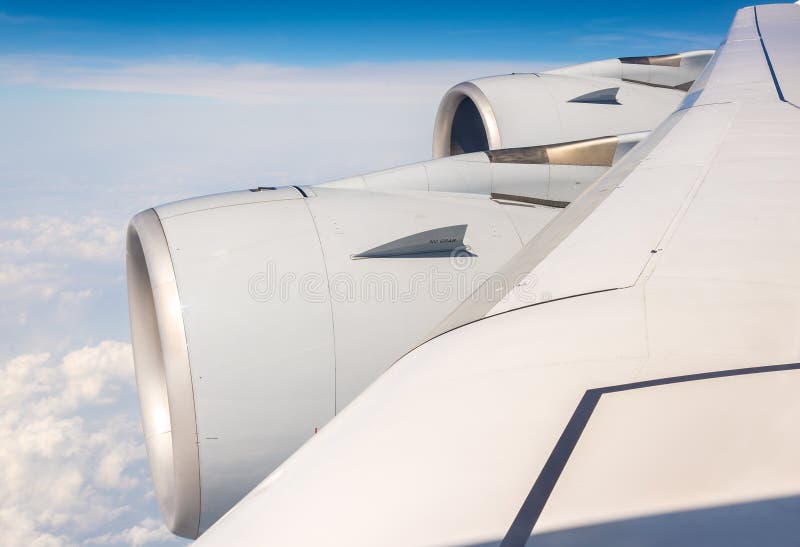 Wing with engines of Airbus A380 flying over clouds stock photos