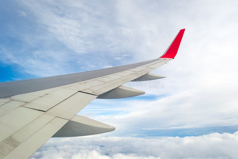 Wing of a plane, blue sky and clouds. stock photo Wing of a plane, blue sky and clouds. stock photo