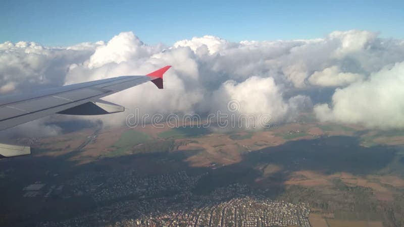 Wing of plane, cloud and land surface at decrease. Frankfurt am Main, Germany; 2018-11-02. Decrease video