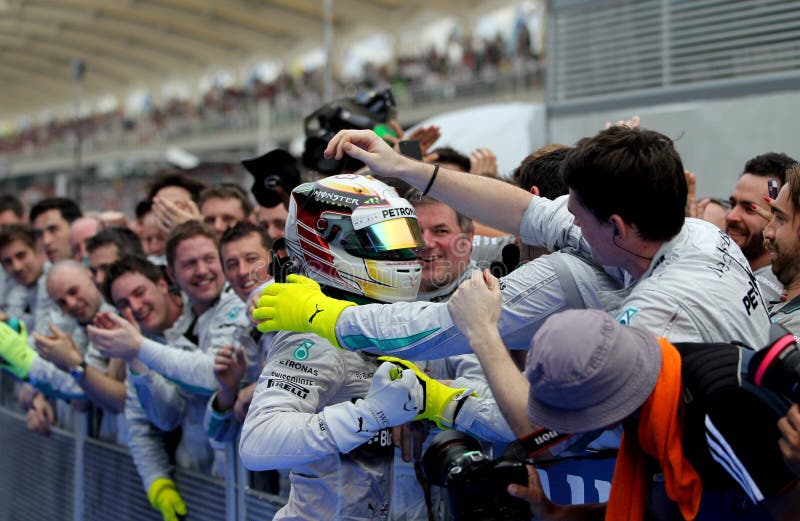 Mercedes AMG PETRONAS driver, Lewis Hamilton celebrate with crew members after winning the Formula One (F1) Grand Prix Malaysia PETRONAS at Sepang International Circuits. Picture taken on: March 30th, 2014. Mercedes AMG PETRONAS driver, Lewis Hamilton celebrate with crew members after winning the Formula One (F1) Grand Prix Malaysia PETRONAS at Sepang International Circuits. Picture taken on: March 30th, 2014