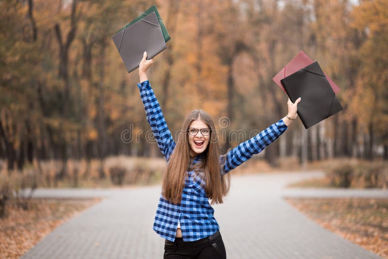 Winner girl euphoric wearing in blue shirt, feeling great things on career way, working toward success and reached it