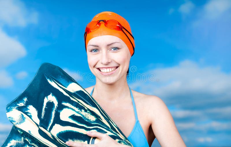 A Winner Young Female Swimmer In An Orange Swimming Cap And Swimming