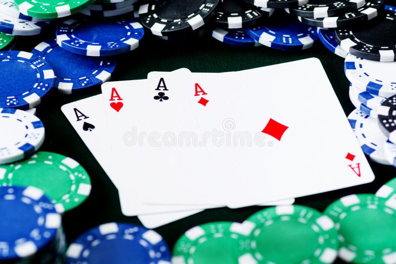 A Winning Poker Hand of Four Aces Playing Cards Suits on Black