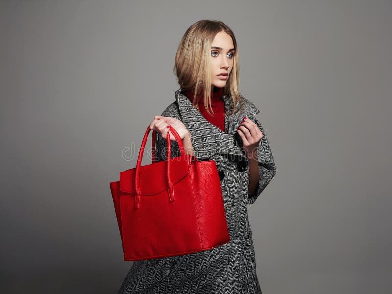 Winter beautiful Woman with Handbag. Beauty Fashion Girl in topcoat