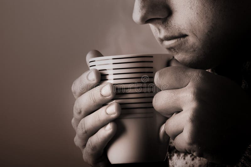 Man drinking warm beverage. Low key image. Sepia toned. Steam from cup. Warm steam stock images, royalty-free photos and pictures