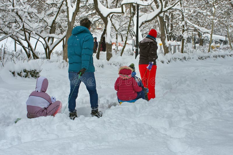 Winter landscape. Winter with snow in Bucharest, Romania. Family in the park stock image