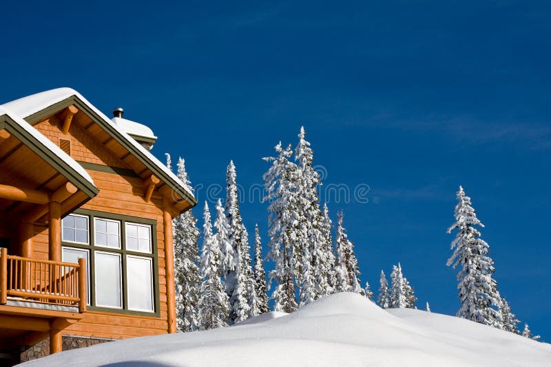 Winter chalet. Log chalet in winter looking out on snow and trees with bright blue sky
