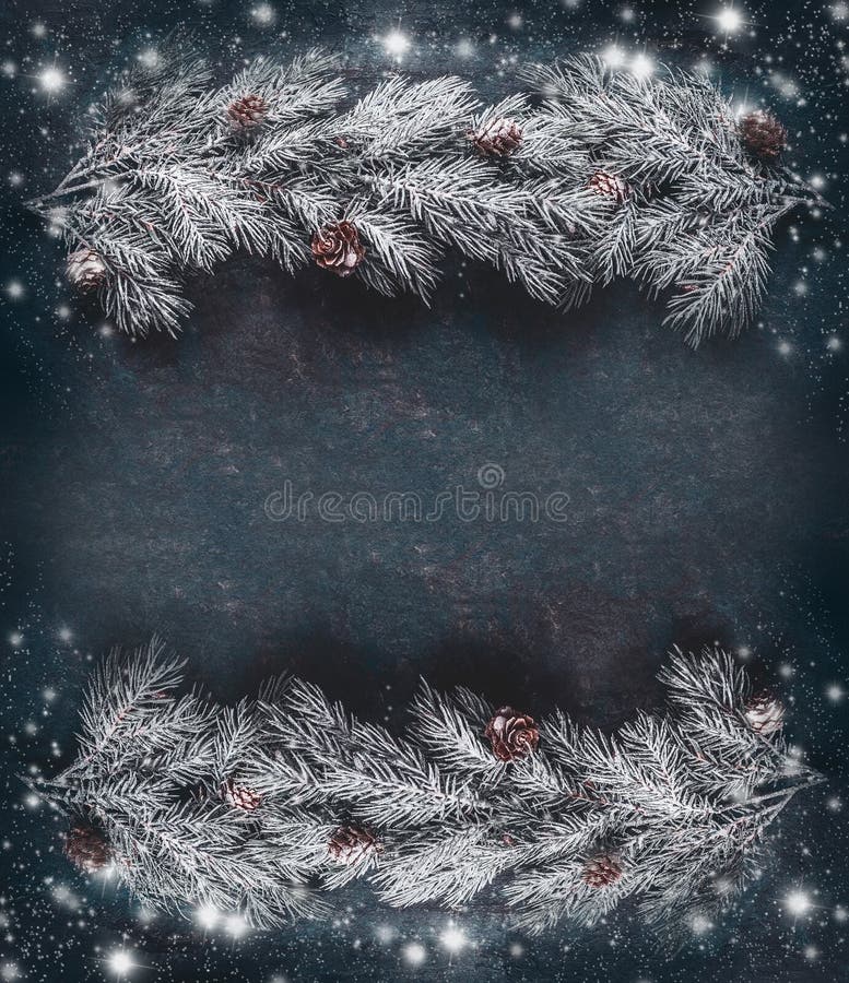 Winter Christmas background frame with hoar and snow covered fir branches with cones, top view