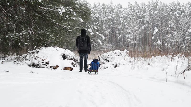 Winter entertainment father and son in forest