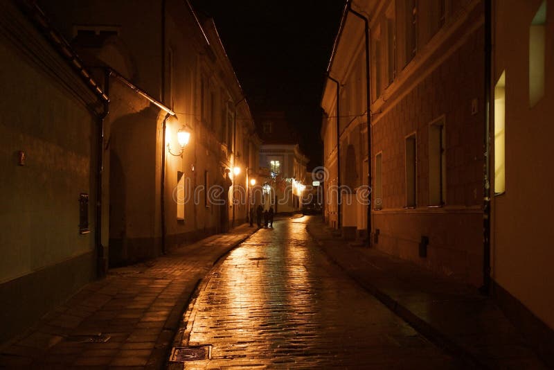 Winter evening on the narrow street of the old town stock photo Winter evening on the narrow street of the old town stock photo
