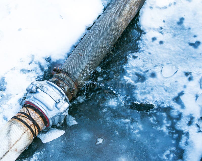 Everything is Covered with Snow. Leak in the Connection of Pipes Pumping Water Out of the Pond