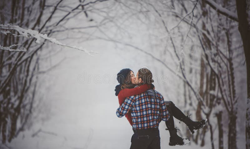 Winter fun couple playful together during winter holidays