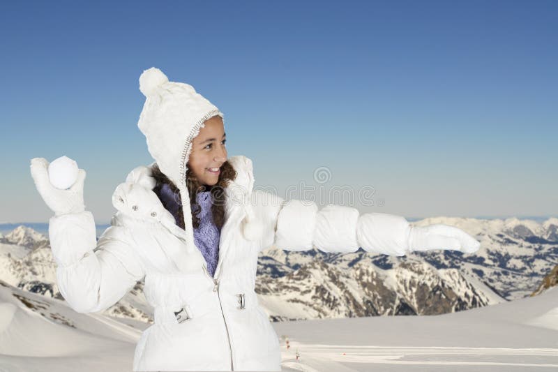 Winter fun, girl throwing a snow ball