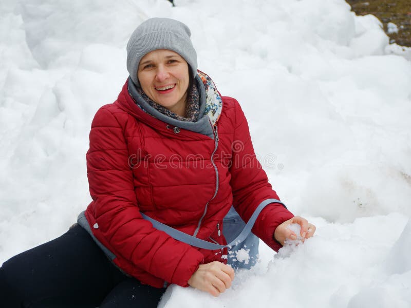 Winter Fun. Woman in a Red Jacket Lies in the Snow Stock Image - Image ...