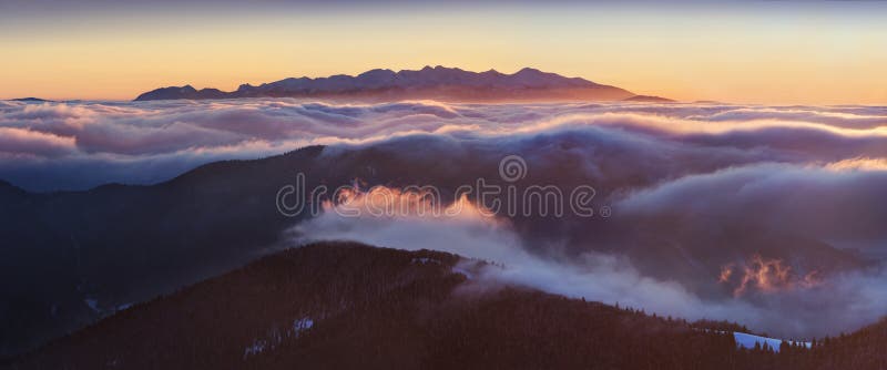 Winter High Tatras mountain range panorama with many peaks and clear sky. Sunny day on top of snowy mountains in winter in Slovakia. Carpathian Sunset from the mountain summit. Fantastic mountains landscape in Europe. Beautiful landscape background concept. Winter High Tatras mountain range panorama with many peaks and clear sky. Sunny day on top of snowy mountains in winter in Slovakia. Carpathian Sunset from the mountain summit. Fantastic mountains landscape in Europe. Beautiful landscape background concept.