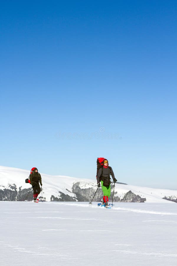 Winter hiking in the mountains on snowshoes with a backpack and tent. Backpack snowshoeing stock images, royalty-free photos and pictures