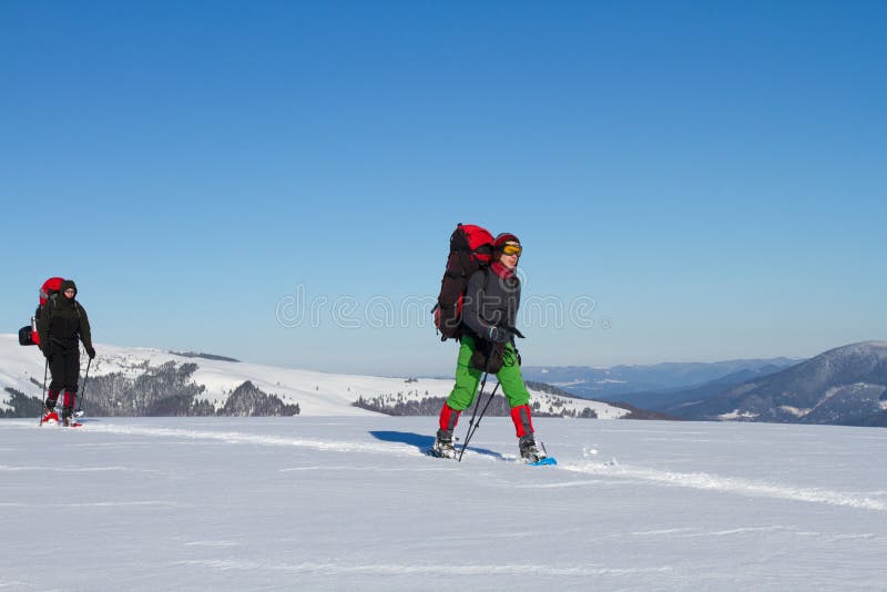 Winter hiking in the mountains on snowshoes with a backpack and tent. Backpack snowshoeing stock images, royalty-free photos and pictures