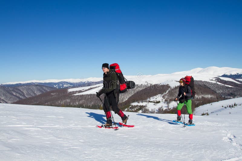 Winter hiking in the mountains on snowshoes with a backpack and tent. Backpack snowshoeing stock images, royalty-free photos and pictures