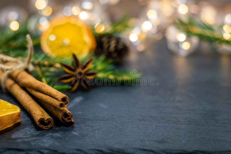 Winter holiday still life concept with dried spices on dark slate board