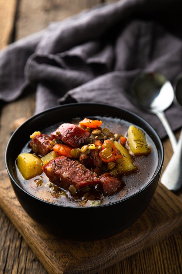 Winter Hot Thick Soup with Lentils and Smoked Sausage Stock Photo