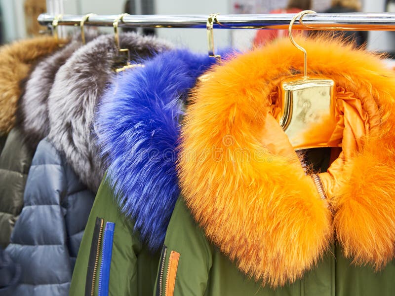 Winter jackets with colored fur collars in clothing store