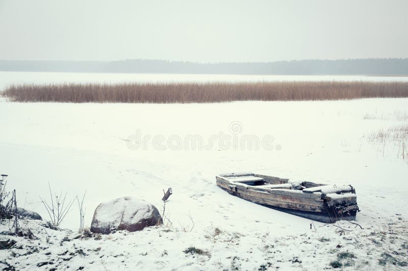 Winter Landscape. Frozen Boat on the Lake.