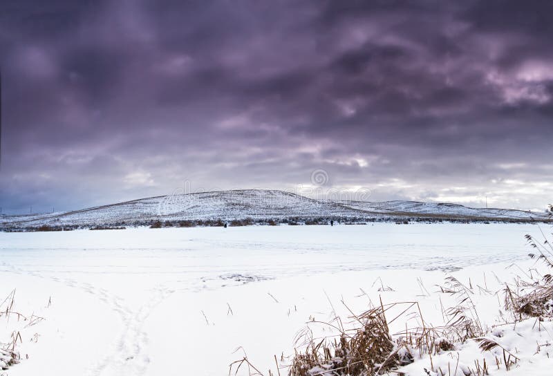 Winter landscape, frozen lake. Snow covered fields