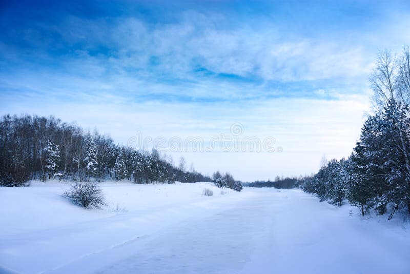 Winter Landscape with Frozen River and Blue Sky